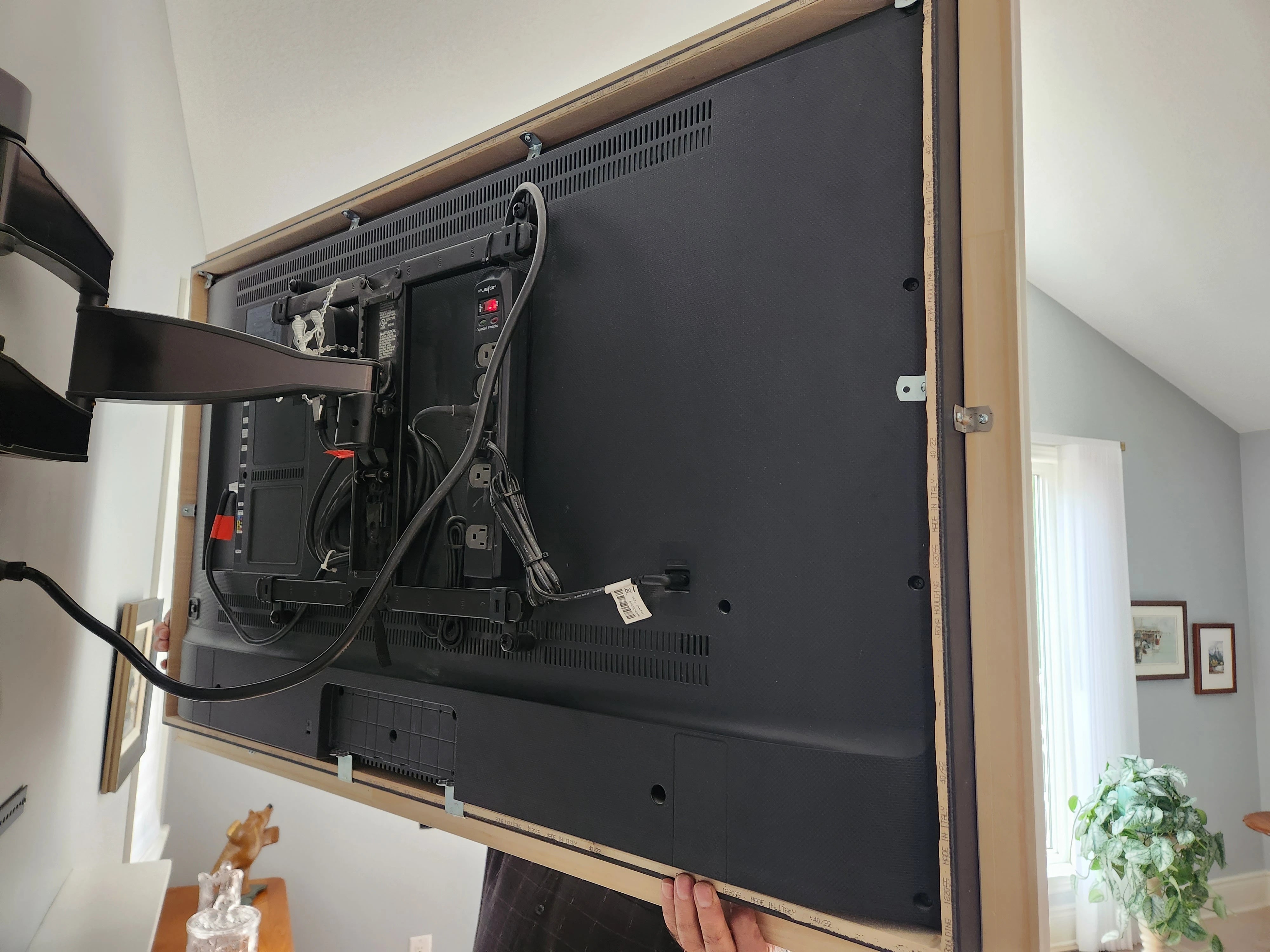 Custom Frame with Art Mode Display - Framed TV showcasing Art Mode, displaying artwork in a cozy, well-decorated space.