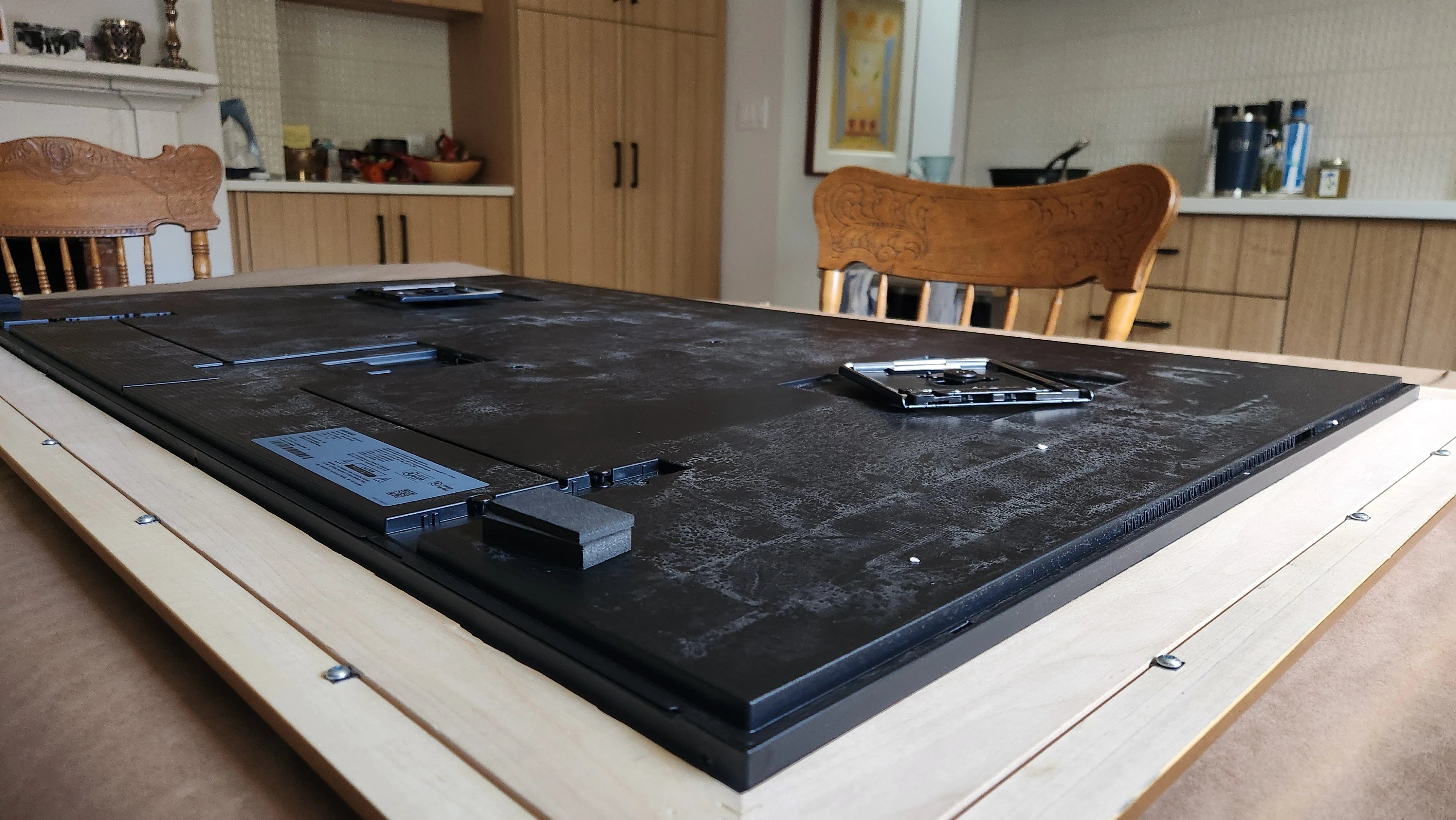 Contemporary TV Frame Design - A custom frame surrounding a TV, complementing a sleek and modern home style.