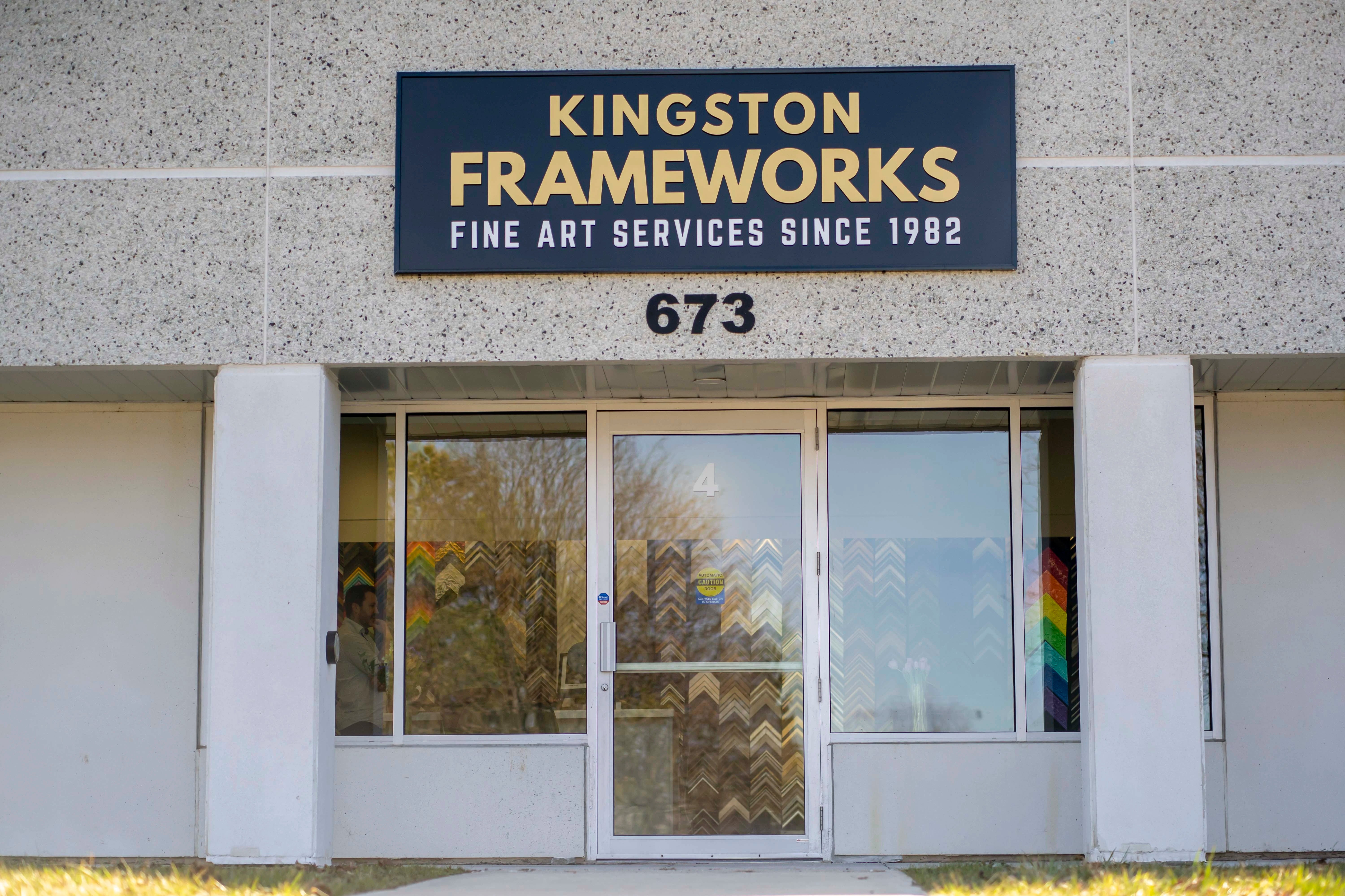 Kingston Frameworks expert answering client questions during a custom framing consultation